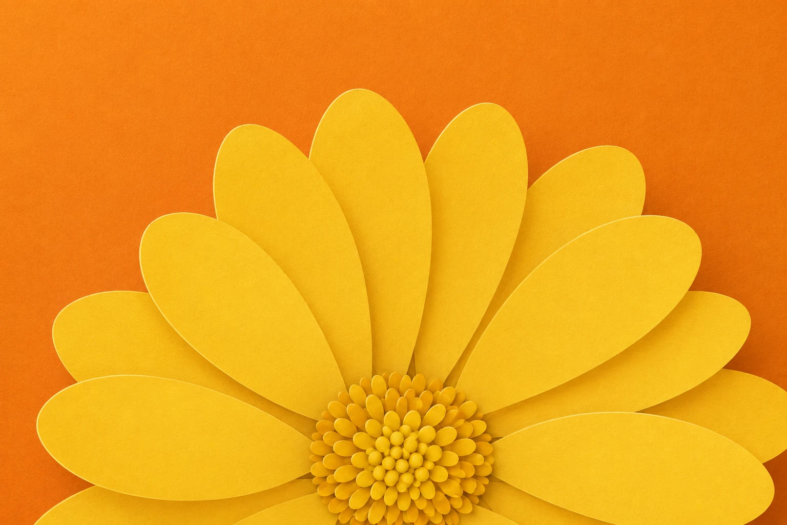 Paper-cut yellow flower on a warm orange background